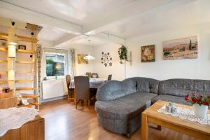 a living room with a couch and a table at Ferienhaus Bruhn in Flensburg