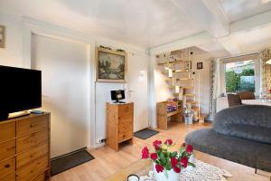 a living room with a couch and a television at Ferienhaus Bruhn in Flensburg