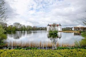 an island in the middle of a lake with a castle at Ferienhaus Bruhn in Flensburg