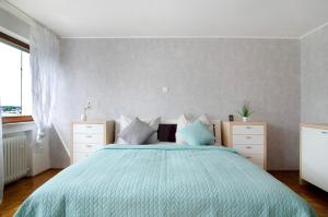 a bedroom with a bed with a blue comforter at Ferienwohnung Marie in Niedereschach