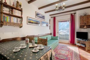 a living room with a table and a couch at Courmayeur 3V21 in Courmayeur