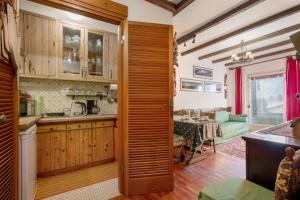 a kitchen with a wooden door leading to a dining room at Courmayeur 3V21 in Courmayeur