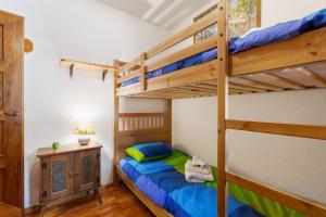 a bedroom with two bunk beds and a desk at Courmayeur 3V21 in Courmayeur