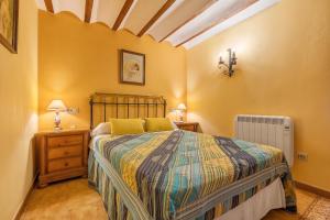 a bedroom with a bed and a radiator at Albahaca in Hinojares