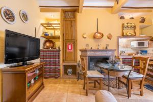 a living room with a tv and a fireplace at Albahaca in Hinojares