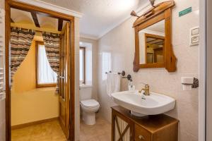 a bathroom with a sink and a toilet and a mirror at Albahaca in Hinojares +22 photos