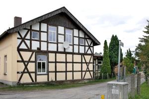 a house with a black and white building at Haus Meistereck Melzow in Melzow
