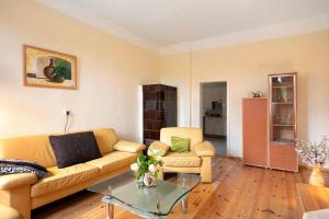 a living room with a couch and a table at Haus Meistereck Melzow in Melzow