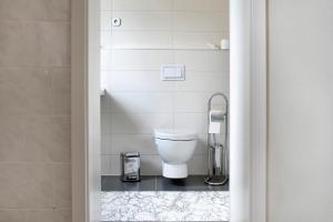 a bathroom with a white toilet in a room at Haus Meistereck Melzow in Melzow +18 photos