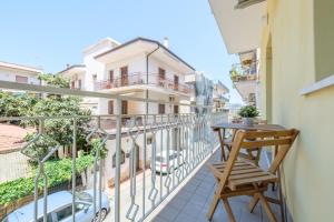a balcony with a table and chair on a building at Paladino in Giardini Naxos
