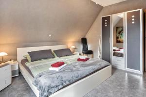 a bedroom with a large bed and a mirror at Münsterland Stadtlohn in Stadtlohn