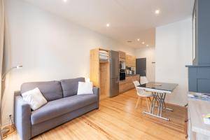 a living room with a couch and a table at Studio cosy & design in Bagnères-de-Bigorre