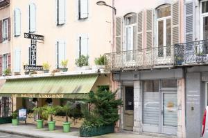 a street corner in a city with a shop at Studio cosy & design in Bagnères-de-Bigorre