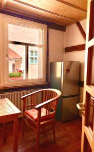 a bench in a room with a window and a refrigerator at Inselgasse in Konstanz +5 photos