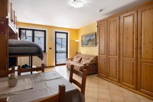 a living room with a couch and a table at Plain Soleil ski home in Prato Nevoso
