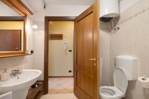 a bathroom with a toilet and a sink at Plain Soleil ski home in Prato Nevoso +19 photos