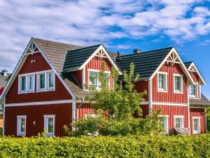 a large red house with white trim at Tine und Claras Ferienhaus in Ringsberg