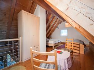 a room with a table and chairs in a attic at Ferienhof Dreher in Meersburg