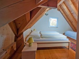 a bedroom with a bed in the attic at Ferienhof Dreher in Meersburg