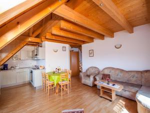 a kitchen and a living room with a table at Ferienhof Dreher in Meersburg