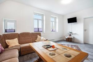 a living room with a couch and a table at Ferienwohnung Dierking in Gilten