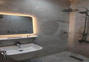 a bathroom with a sink and a shower with a mirror at شقة المطيري in Jeddah