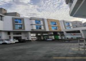 a large building with a parking lot in front of it at شقة المطيري in Jeddah
