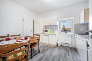 a kitchen and dining room with a table and chairs at Ferienwohnung Dierking in Gilten