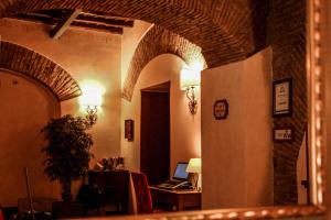 a room with an archway with a laptop on a desk at Residenza San Calisto in Rome