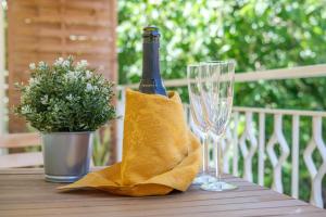 a bottle of champagne and two glasses on a table at Paladino in Giardini Naxos