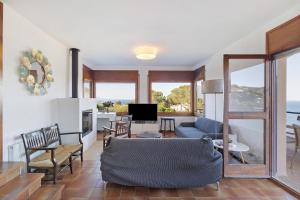 a living room with a couch and a tv at Racó 72 in Begur