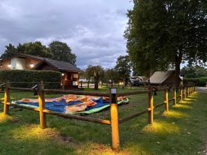 a blanket laying on the grass next to a fence at Camping Arquebuse in Auxonne
