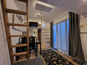 a small room with a staircase and a large window at Planinski Dom na Travni Gori in Sodražica