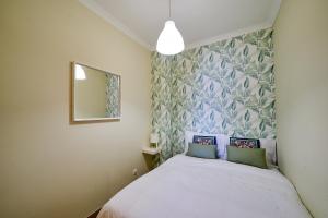 a small bedroom with a bed and a mirror at Penthouse Monte da Eira - Sunset in Albufeira +15 photos
