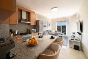 a kitchen with a bowl of fruit on a counter at Penthouse Monte da Eira - Sunset in Albufeira