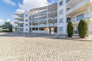 a large white building with trees in front of it at Penthouse Monte da Eira - Sunset in Albufeira