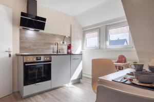 a kitchen with a sink and a stove top oven at Ferienwohnung Harzreich in Seesen +16 photos