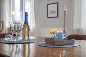 a bottle of wine sitting on a table with glasses at Ferienwohnung Harzreich in Seesen