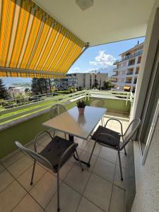 a table and chairs on a balcony with a view at Minusio Swiss Vacances in Minusio