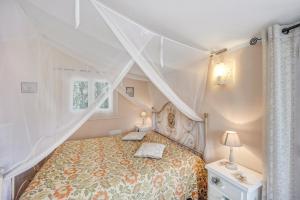 a bedroom with a canopy bed and a window at Casa Paola e del Poeta in Costa Carnara +16 photos