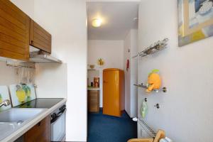 a kitchen with a sink and a orange refrigerator at Der Falkenhorst in Bad Sachsa
