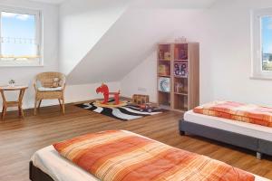 a bedroom with two beds and a table and a chair at kleine Auszeit in Albbruck