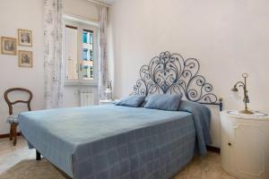 a bedroom with a bed with a blue bedspread at Zaffiro Apartment With Garage in Rapallo