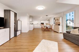 a large living room with a couch and a kitchen at kleine Auszeit in Albbruck