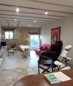 a living room with a red couch and chairs at Chambres d' hotes Terre Happy in Ribérac