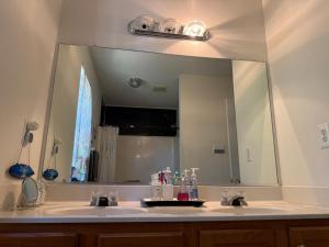 a bathroom with two sinks and a large mirror at Wonderful room in great neighborhood near Downtown in Richmond +18 photos