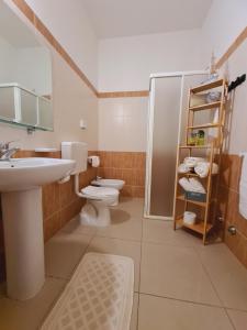 a bathroom with a toilet and a sink and a shower at Club Vacanze In in Cervia +55 photos