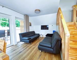 a living room with a couch and a chair at Ferienhaus 88 in Bad Arolsen