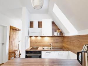 a kitchen with white cabinets and a sink at Ferienhaus 88 in Bad Arolsen