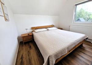 a bedroom with a bed and a window at Ferienhaus 88 in Bad Arolsen